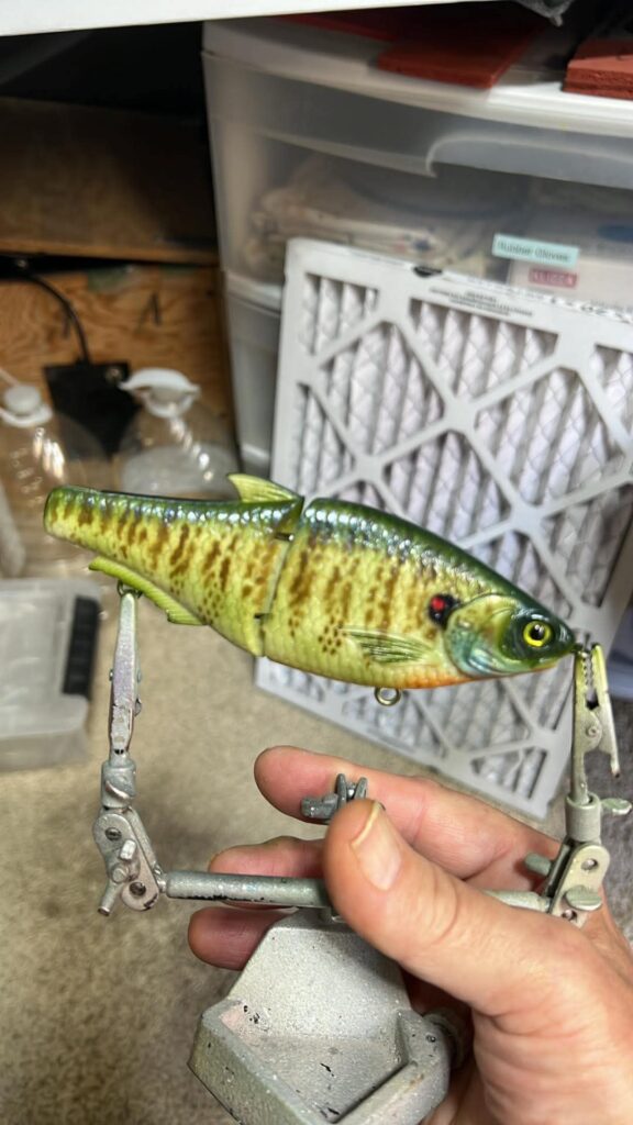 Bluegill-pattern jointed swimbait painted with scale stencils